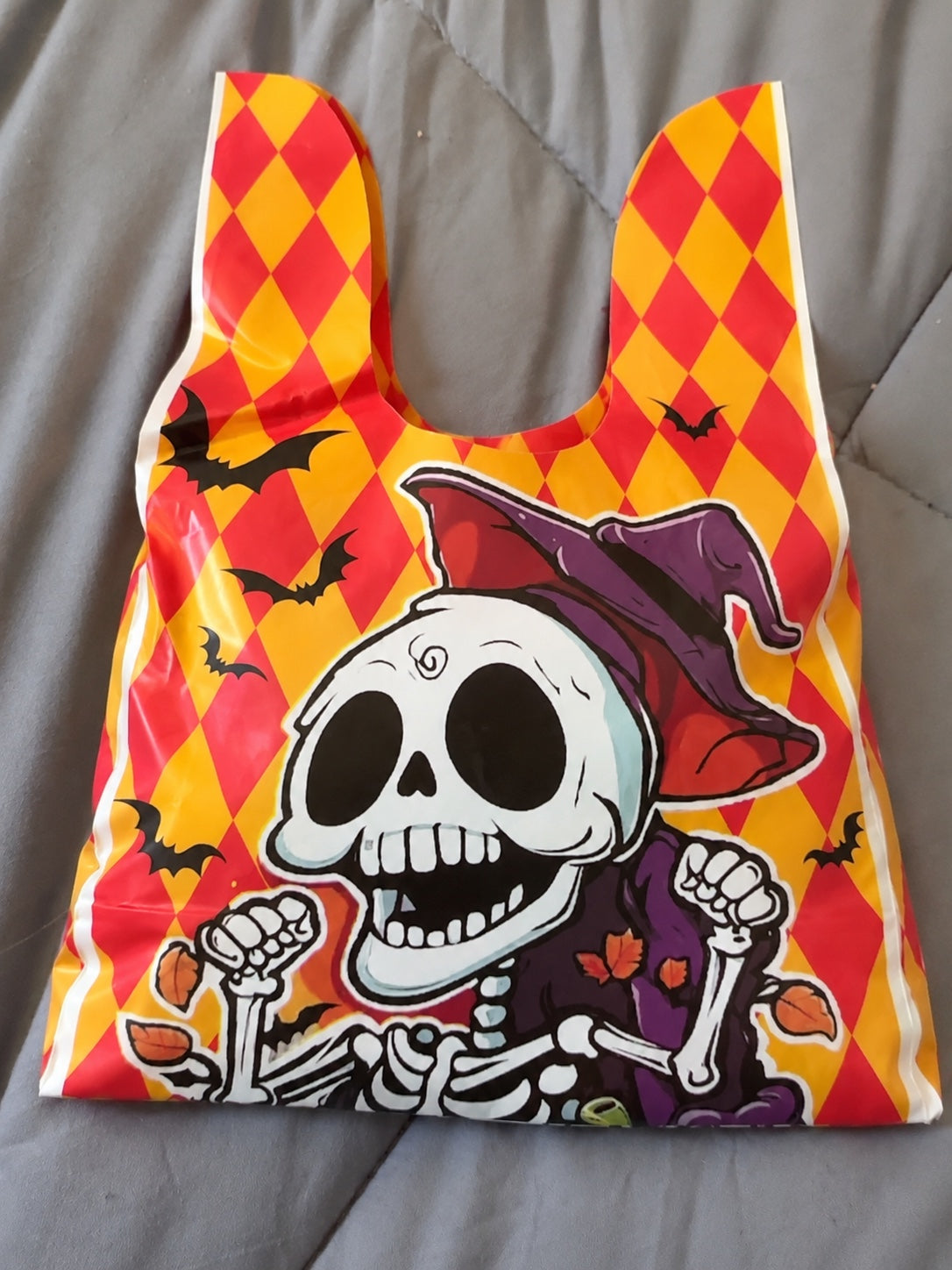 Halloween Trick or Treat Mystery Bag with red and yellow diamonds and smiling skeleton witch