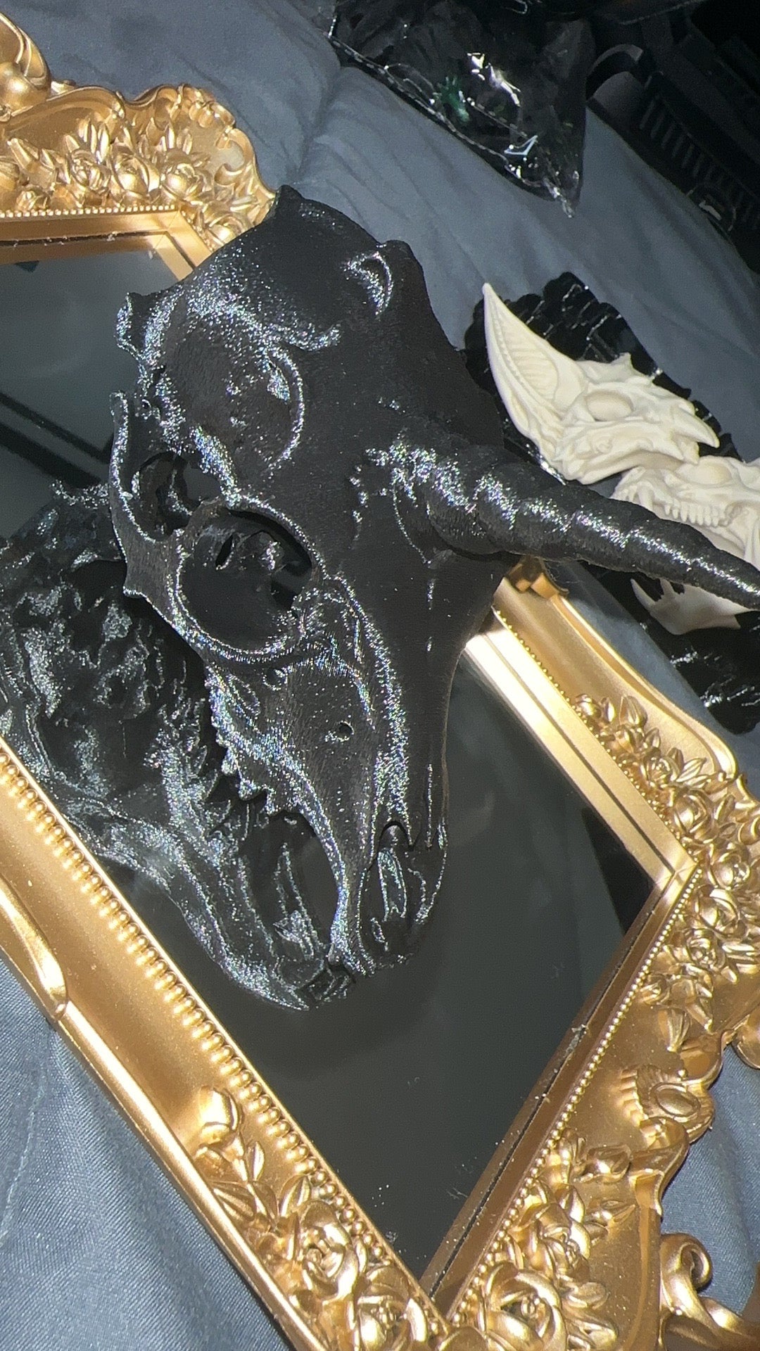 Black 3D printed unicorn skull with long horn and elongated bone structure