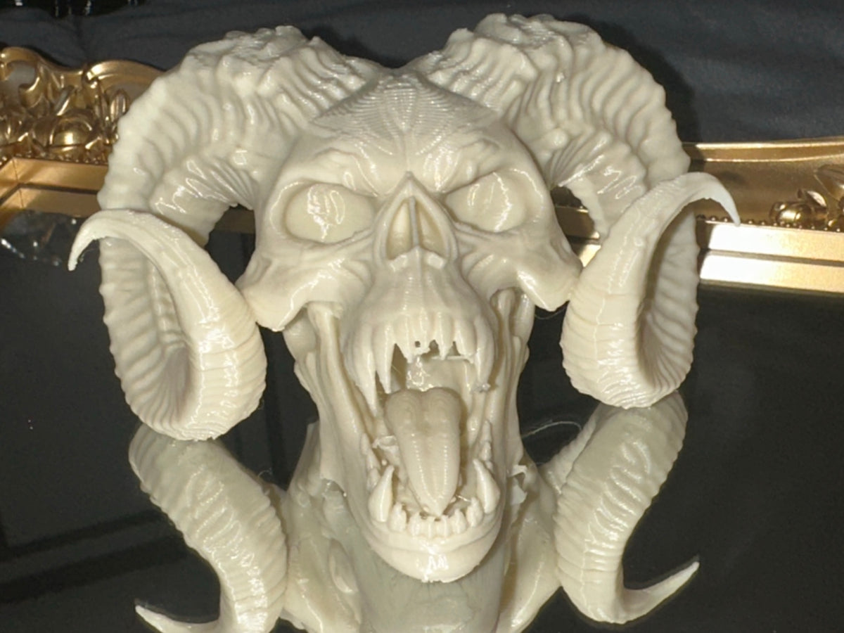 3D printed demon skull with curled horns and tongue in bone white