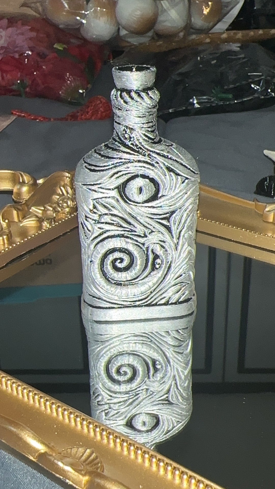 Silver and black hand finished 3D printed poison bottle with raised eye and spiral details