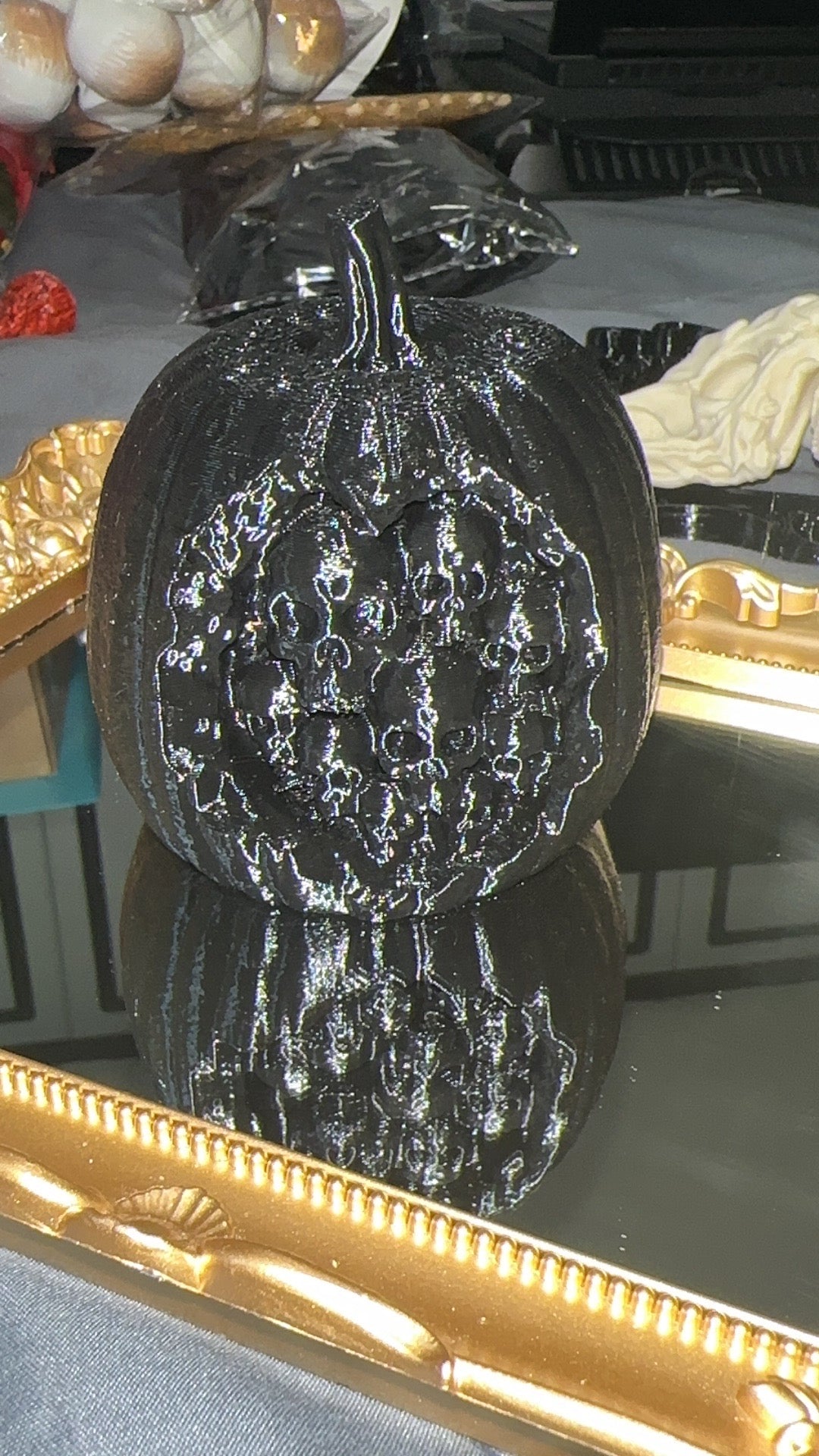 Black 3D printed rotten apple filled with skulls