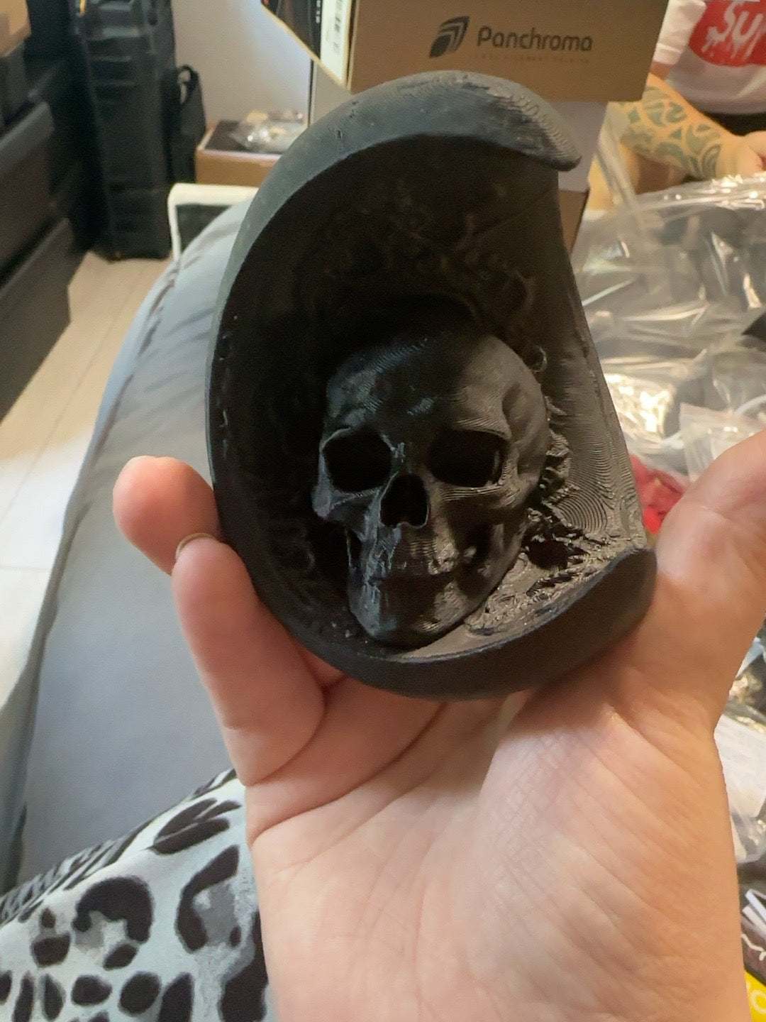 Black 3D printed skull inside a crescent moon