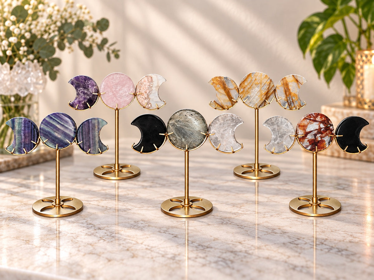 Five Triple Moon crystal displays on bronze tone stands